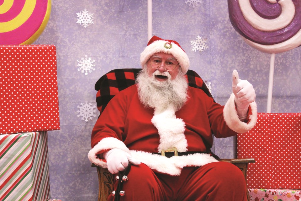 Santa Claus gives a thumbs up from his chair at New Horizon Mall in Balzac. While children are not able to sit on Saint Nick's lap this year, Santa is still able to pose for socially-distanced photos. Photo by Scott Strasser/Airdrie City View.