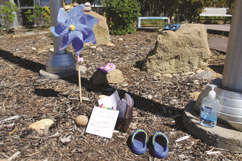 Baby shoes and notes of condolences were left at the base of the flag pole by Airdrie City Hall this week, as a tribute to the 215 First Nations youth whose remains were discovered buried below the site of the former Kamloops Indian Residential School last week. The City's flags were also flown at half mast.
