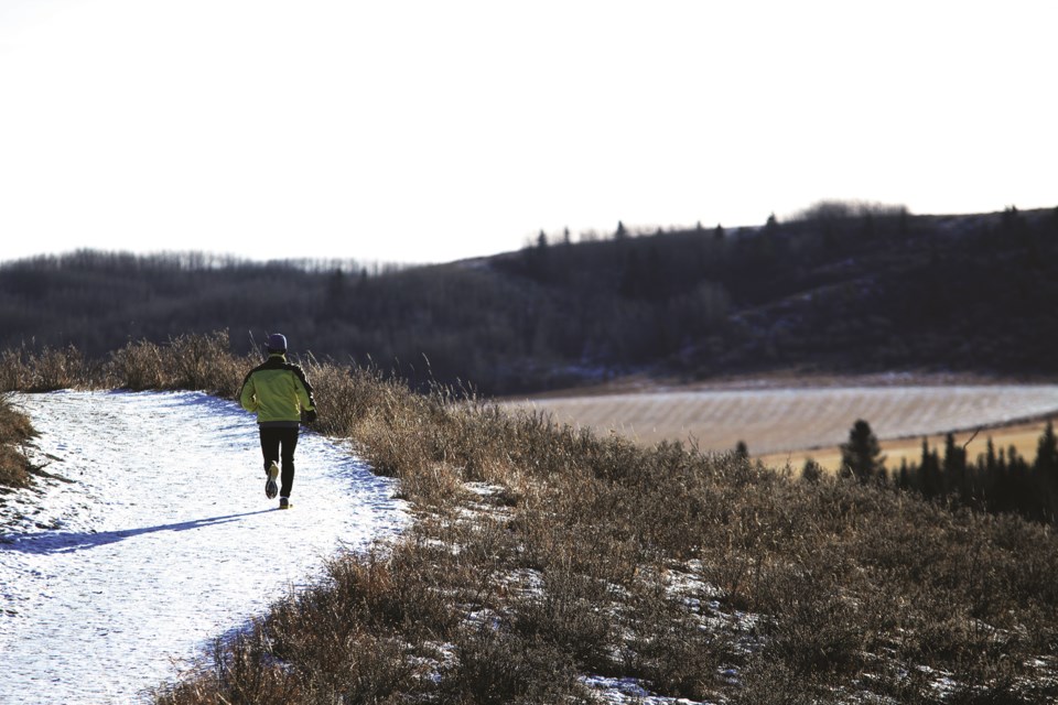 A jogger makes his way along a pathway in Glenbow Ranch Provincial Park.