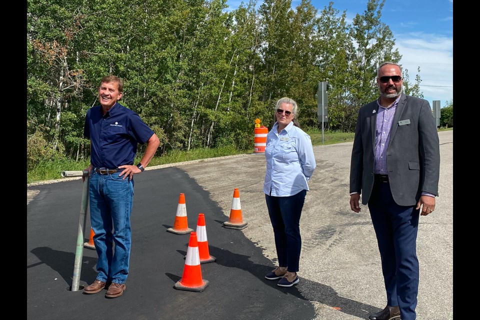 Rocky View County Mayor Don Kochan, Deputy Mayor Crystal Kissel and Coun. Sunny Samra take part in a valve-turning ceremony to officially dedicate the new water supply flowing into Prince of Peace through the Conrich Water Extension on Aug. 29.