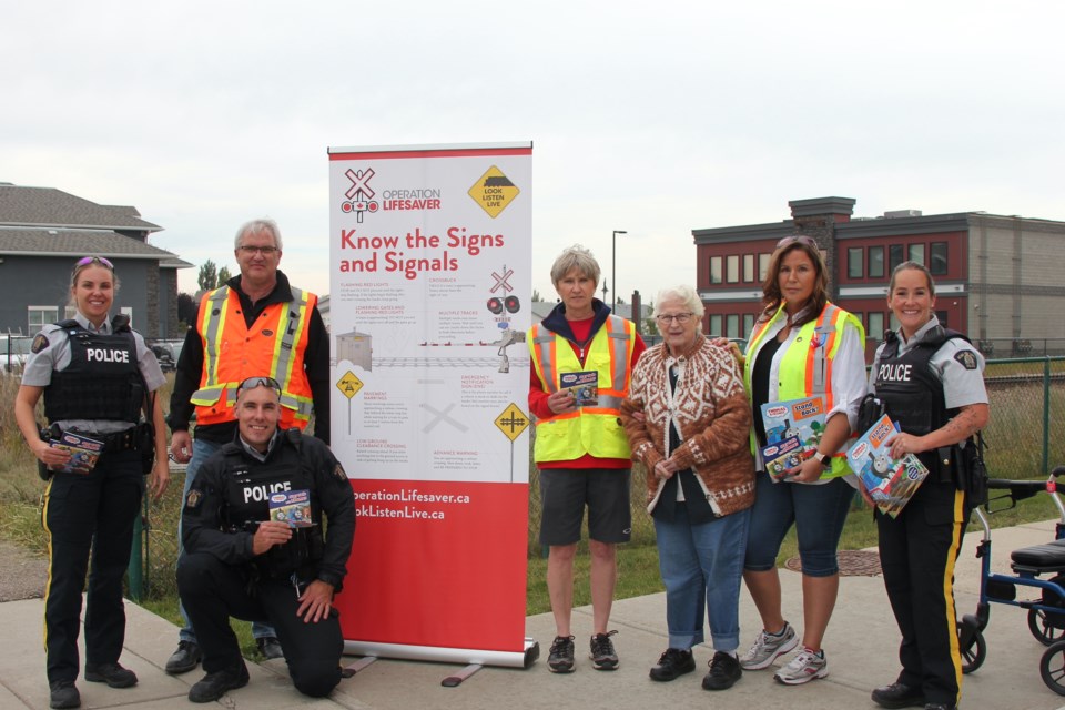 The family of Andrew West, who was killed by a train in 2001, and local RCMP officers, held an awareness event on Sept. 25, handing out flyers and reminding people to be careful around local railway tracks.