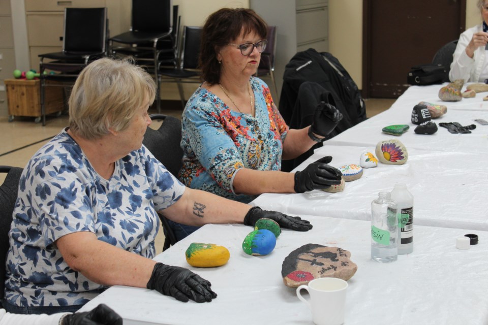 Painted rocks by the Airdrie Over 50 Club at the Town and Country Centre on May 8, 2024. The rocks will be distributed around town at various public places to uplift community spirit.