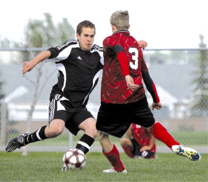 George McDougall&#8217;s Steven Phee looks to move the ball against this Chestermere defender in the Rocky View Sports Association soccer final held at Monklands Soccer Park