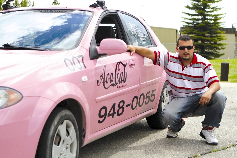 Avacab Taxi&#8217;s Inc. owner Mohamed Benini poses next to one of his pink taxis at Nose Creek Park, June 11. Part of each fare in the pink cars will be donated to the