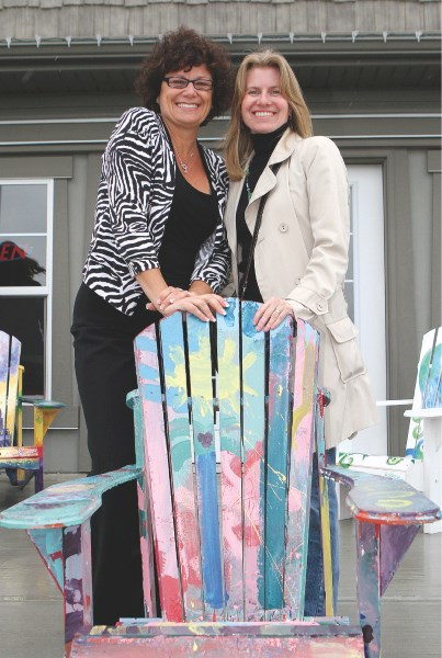 Airdrie publisher Sherry Shaw-Froggatt poses for photos with local artist Veronica Funk at the launch of the AIRdirondack community art project at a Qualico Showhome in