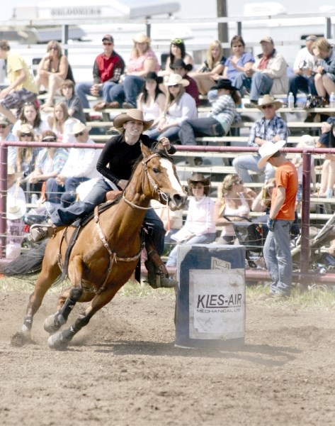A competitor looks towards the finish during ladies barrel racing at the Pete Knight Days rodeo in Crossfield, June 19.