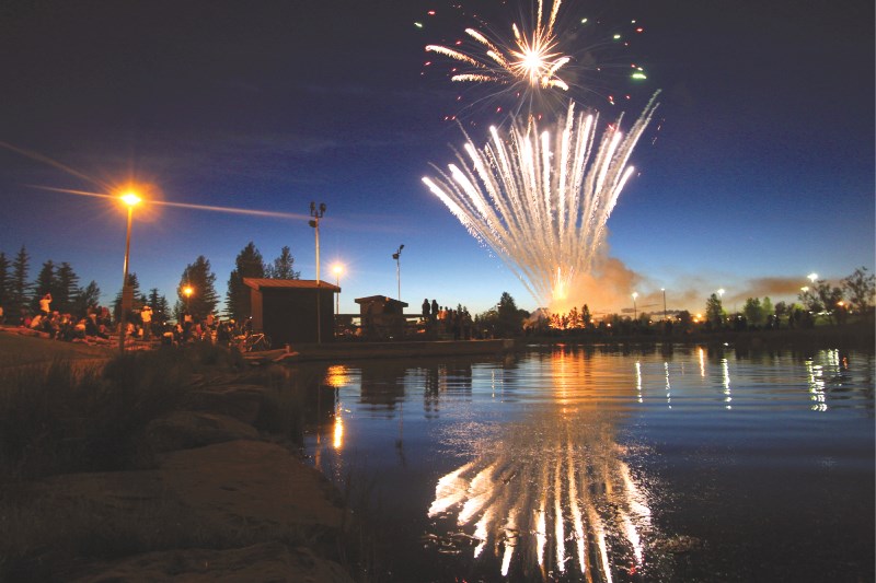 The Canada Day fireworks display is reflected in the waters of Nose Creek, July 1 in Airdrie.