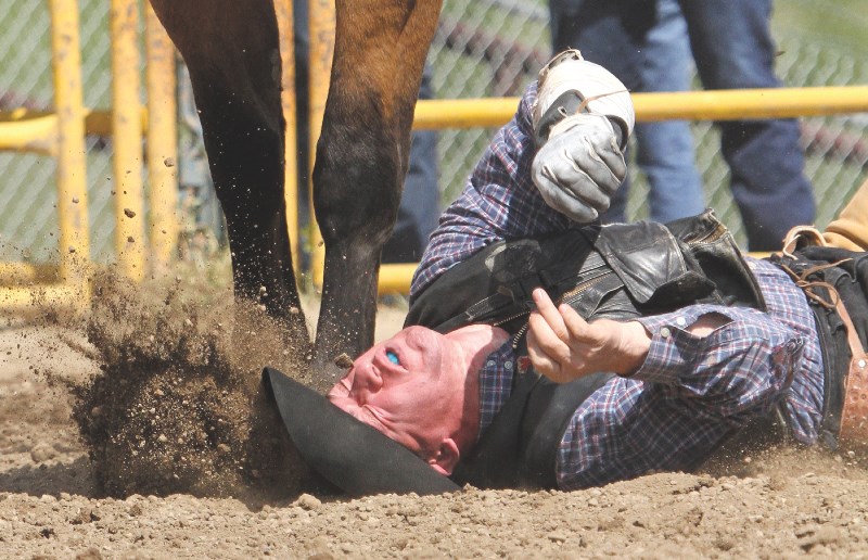 Anthony Hodson of Turner Valley eats dirt after being bucked off Wishbone in the Bareback, July 1.