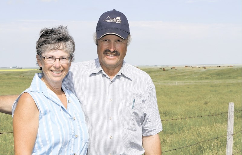 Linda and Doug Wray pose for photos at their farm near Irricana, July 28.