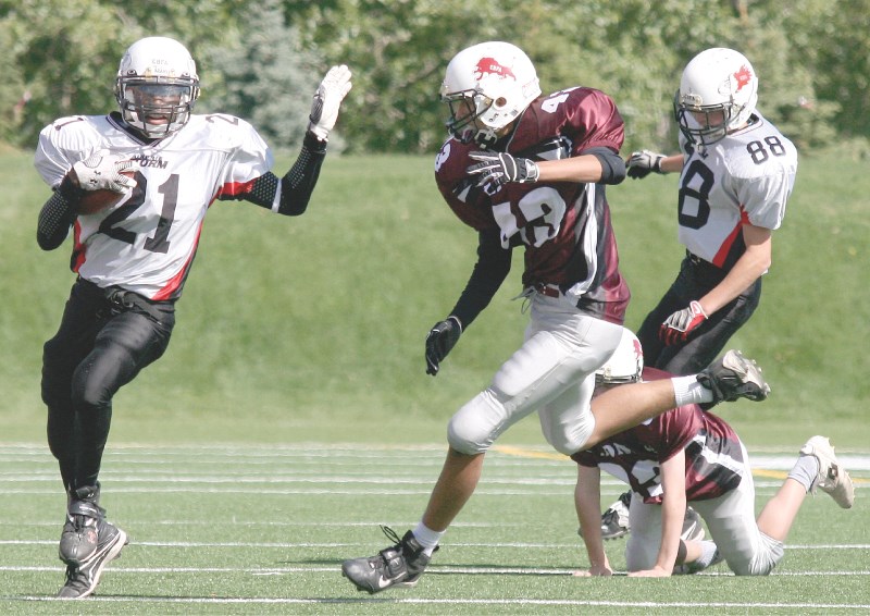 Airdrie Storm wide receiver Nathaniel Cross gives Cochrane linebacker Matt Pipa a straight arm en route to a 70-yard touchdown during the Storm&#8217;s 38-30 win on Aug. 28.