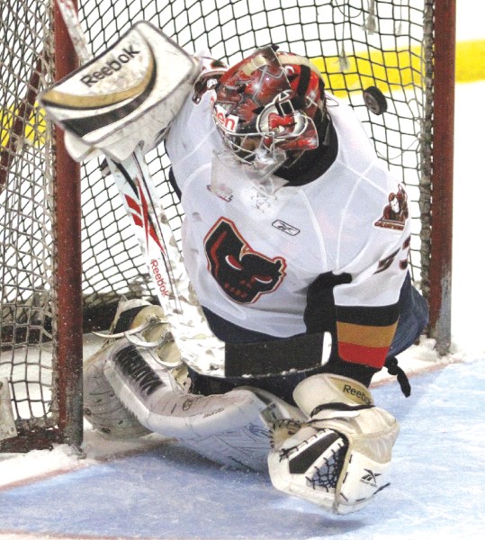 One squeaks past Calgary Hitmen netminder Juraj Holly during a preseason game against the Red Deer Rebels, Sept. 9 at the Ron Ebbesen Arena in Airdrie.