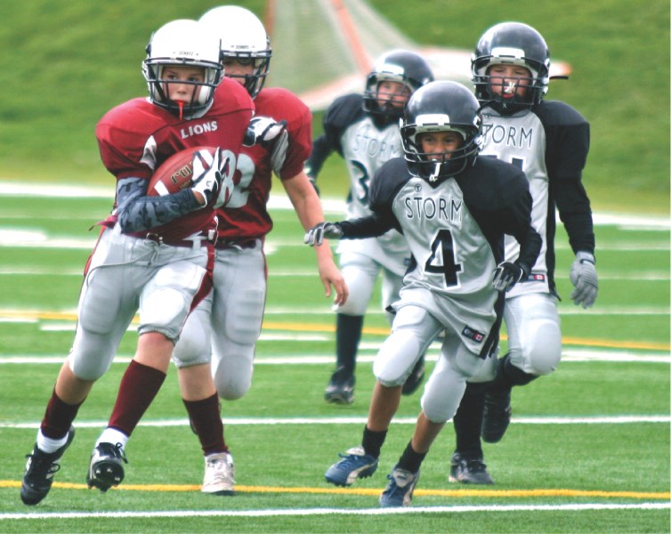 Cochrane running back Alexander Tychonick has a big gain during the Lions&#8217; 46-0 win over the Storm on Sept. 18 at Shouldice Park in Calgary.