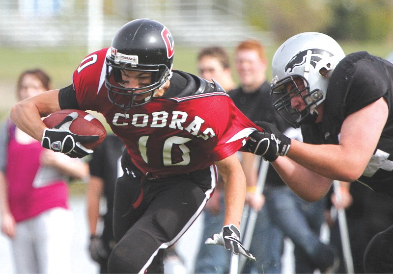 Cochrane receiver Eric Patterson eludes a George McDougall tackle en route to his 57-yard touchdown, as the Cobras beat the Mustangs 63-7 at Airdrie&#8217;s Genesis Place on