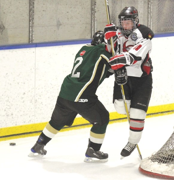 Justin Hamilton of the Calgay Northstars separates Xtreme captain Colby Chartier from the puck during Airdrie&#8217;s final regular season game, Feb. 13.