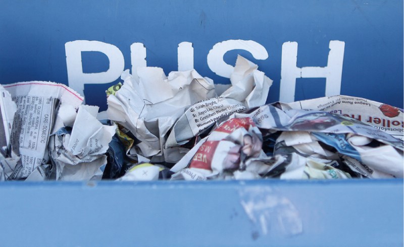 Papers are seen overflowing from the recycling bins at the Westside Recycling Depot, March 28. The City is encouraging residents to do their part to help keep the site clean.