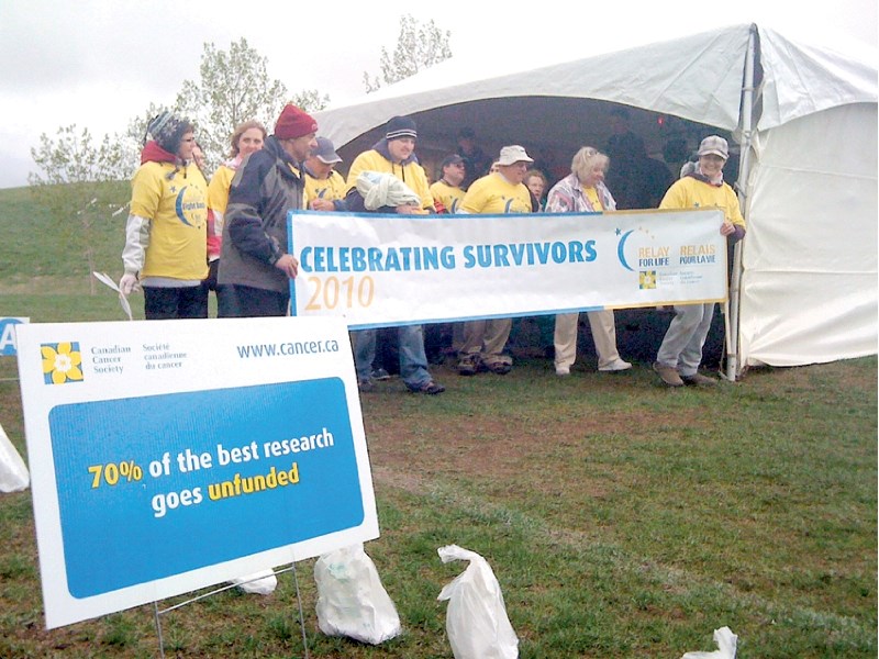 Those who have beat cancer take to the track for the Survivors&#8217; Lap during the very wet and chilly 2010 Airdrie Relay for Life May 28.