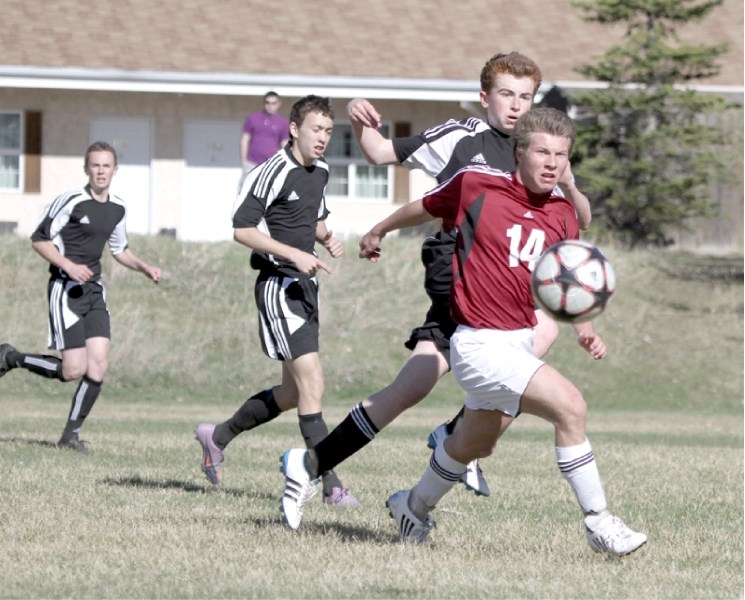 Cobras&#8217; striker Coleson Dell looks to create a scoring chance during his team&#8217;s 2-1 win over the George McDougall Mustangs at Mitford Pond in Cochrane, May 17.