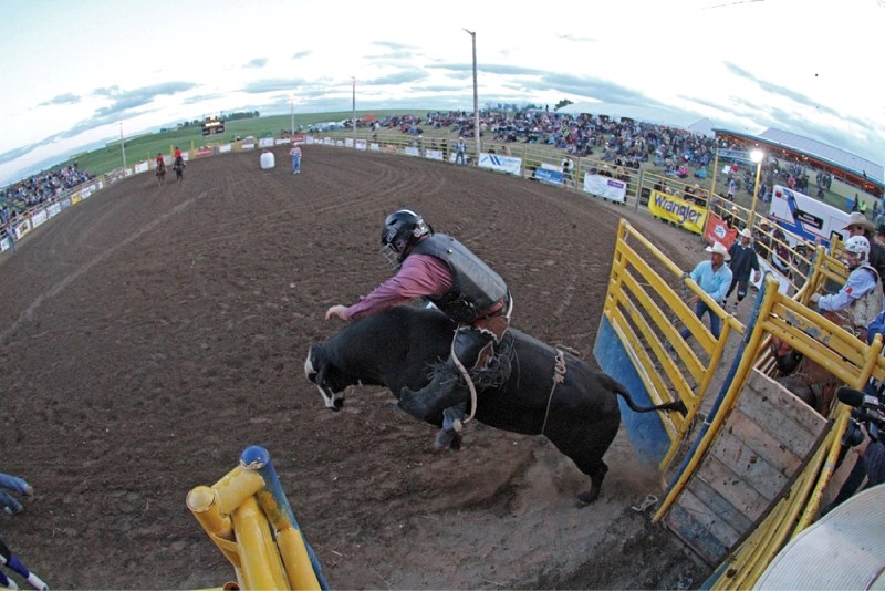 Crossfield bull rider Kyle German explodes out of the chute atop Optimus Prime, June 30.