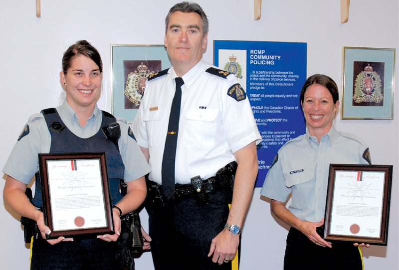 Const. Cindy Templeman, Insp. Tony Hamori and Const. Mara Peterson stand with the St. John Life Savings Awards presented to them at the RCMP detachment, July 6. The two