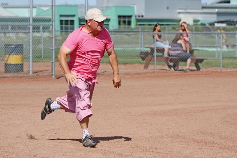 Airdrie Mayor Peter Brown makes a dash towards first base during the third annual Batting Against Breast Cancer slo-pitch tournament at Chinook Winds Ballpark, Aug. 6.