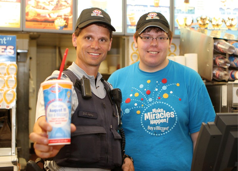 Airdrie RCMP Const. Dave Henry poses for a photo with Dairy Queen employee Alex Adams on Miracle Treat Day, Aug. 11. The fundraiser collected more than $25,000 in Airdrie