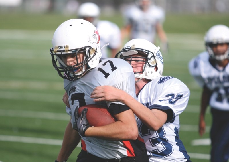 Storm running back Jordan Baldwin tries to escape a tackle from a Cyclones defender during Airdrie&#8217;s 27-12 loss to Calgary at Shouldice Park, Aug. 27. Baldwin had two