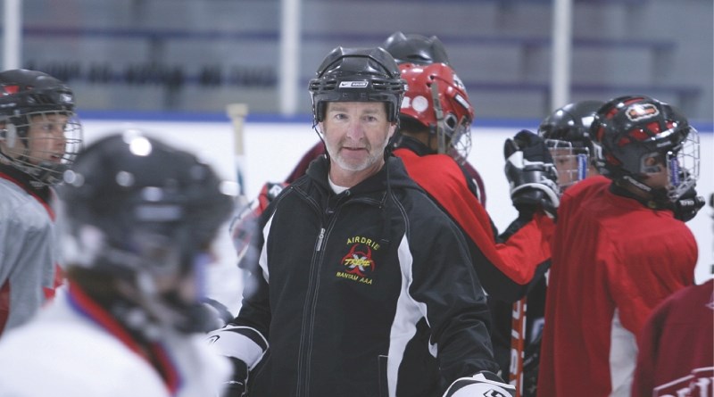 Airdrie Xtreme head coach Terry Keogh looks over his squad during conditioning camp at the Ron Ebbesen Arena, Aug. 30.