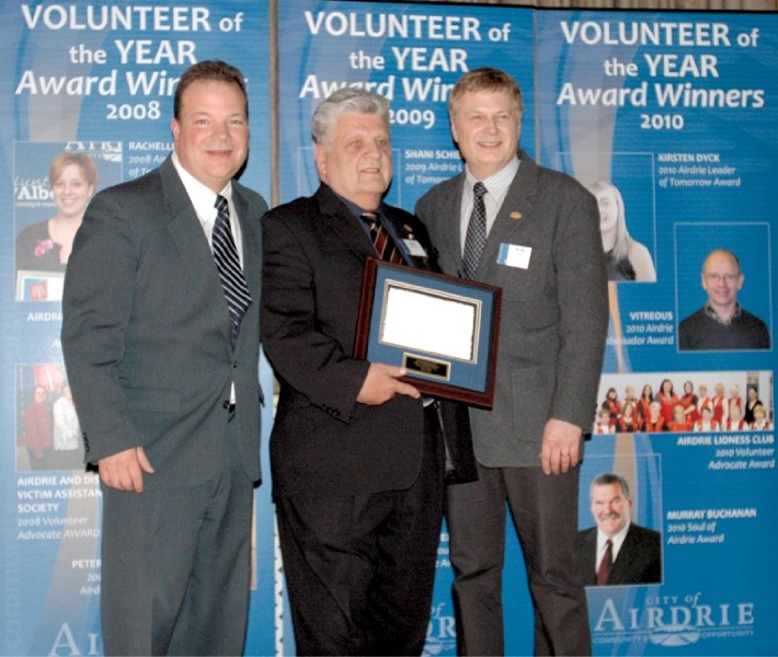 Dick Buchanan, middle, won the city&#8217;s Volunteer of the Year Ambassador Award earlier this year. Now, he has captured the Business Leader Award from the Airdrie Chamber