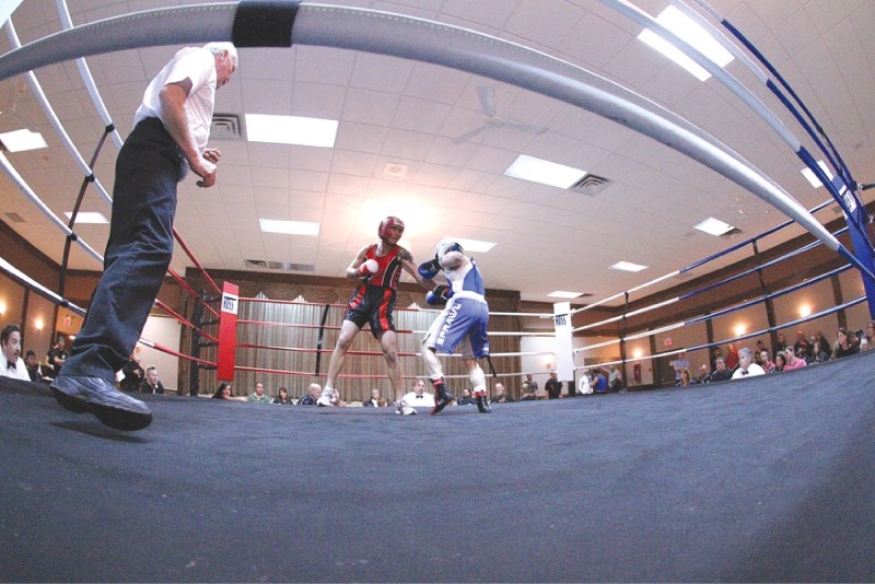 Airdrie&#8217;s Jeff Ter Mors (in red) fights Chris Cinnamon, from Sweet Science Boxing in Fort McMurray, during Boss Brawl 2 held at the Airdrie Town and Country Centre,