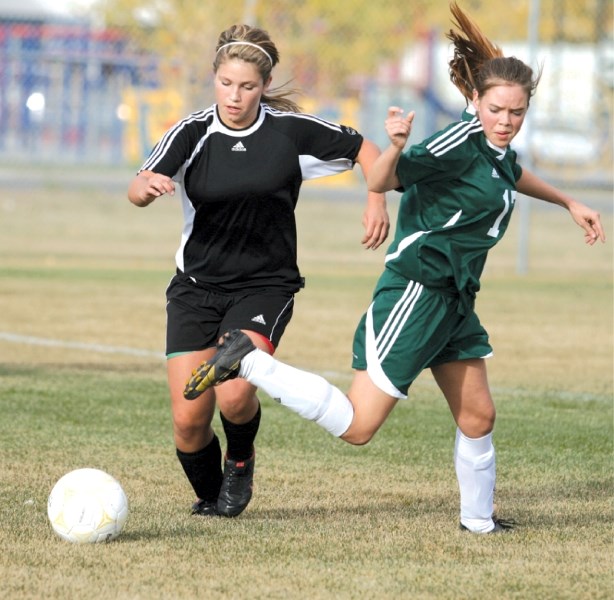 Mustang Ayla Weemaels, who scored her team&#8217;s first goal, moves the ball past Phoenix defender Jenny McFadyen, during George Mac&#8217;s 2-1 extra time victory over