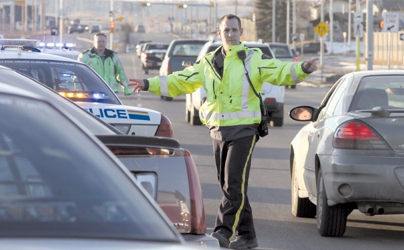 About eight Airdrie RCMP officers set up a checkstop at the Highway 2 overpass at Yankee Valley Boulevard, Dec. 29, where an accused carjacker was apprehended.