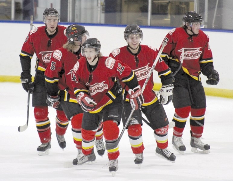 Alex Hustad leads his Thunder teammates towards the bench for a celebration after his game-winning goal in Airdrie&#8217;s 4-1 win over the Blackfalds Wranglers at the Ron