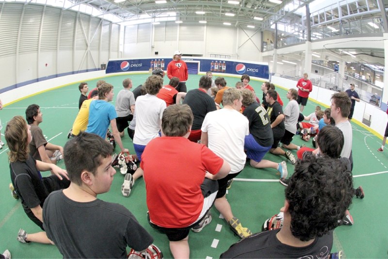 The Northern Raiders Midget football club listens to head coach Steve Kemp speak during the team&#8217;s two-day skills camp, held at Genesis Place Jan. 26-27.
