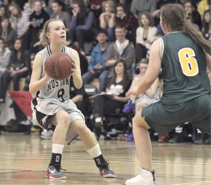 The Mustangs&#8217; Amanda Kerr, who was named a tournament all-star, lines up a shot in front of a packed crowd during the opening game of the 16th annual George McDougall
