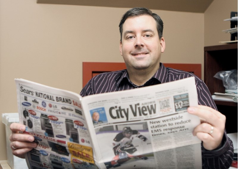 Airdrie City View Publisher Cam Christianson thumbs through last week&#8217;s edition, Feb. 28.