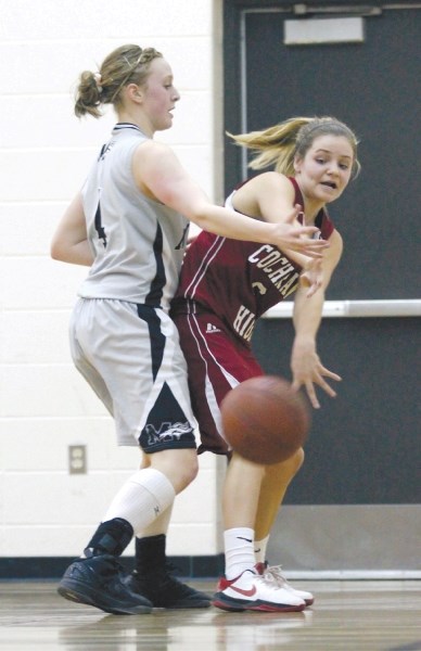 Cochrane&#8217;s Bailey Sethyenko passes the ball past the Mustangs&#8217; Kylie Lebedeff, who had a game-high 32 points, during the Cobras&#8217; 56-50 RVSA gold medal win