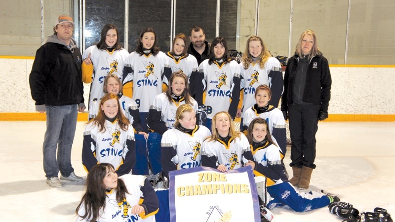 Members of the Airdrie U-14 Sting ringette team celebrate its Big Country Zone Championship win in Strathmore on March 3. The team beat the Strathmore Ice 10-3 in the final