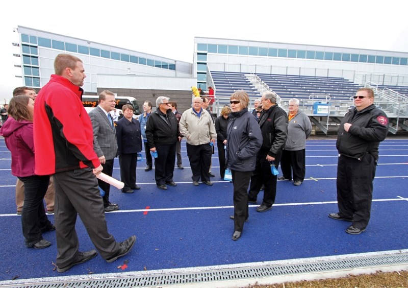 The 2014 Alberta Summer Games Selection Committee and community members inspect the track at East Lake Athletic Park, April 18.