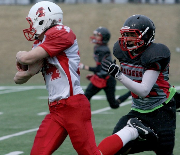 The Northern Raiders&#8217; Jared Johnson tackles a member of the Calgary Broncos, April 26. The Raiders lost to the Broncos 13-36, but managed to score their first points of 