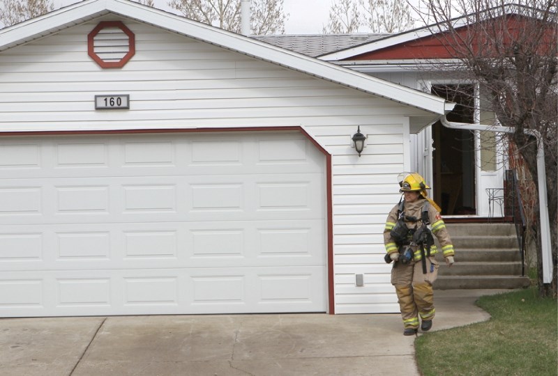 An Airdrie firefighter leaves a home in Big Springs after responding to a false structure fire called in at about 4:45 p.m. on May 2. A pot was left on the stove, and began