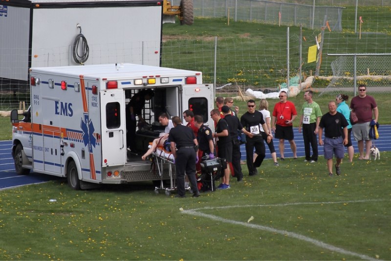 A runner who collapsed only 150 metres from the finish of the race is loaded into an ambulance during the Airdrie Mayor&#8217;s Run at Genesis Place, June 3.