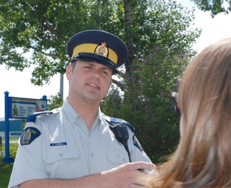 Corporal Darrin Turnbill talks to the media after an Irricana-area fatal collision, June 21. Police are looking for the driver of a Dodge pickup, who is injured, after he or