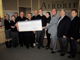 The Airdrie 2014 Alberta Summer Games Society accepts the second $100,000 installment of City funds in support of the Games during a council meeting April 15.