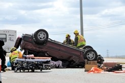 EMS crews attend to the occupants of an overturned vehicle on Highway 2 on July 28. Airdrie ITU officers believe that accident occurred after the occupants of the vehicle