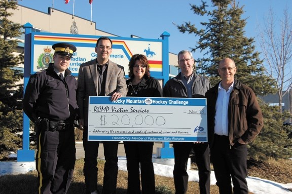 MP Blake Richard (second from left) presents a cheque for $20,000 to members of the Airdrie and District Victims Assistance Society. Funds came from the Rocky Mountain Hockey 