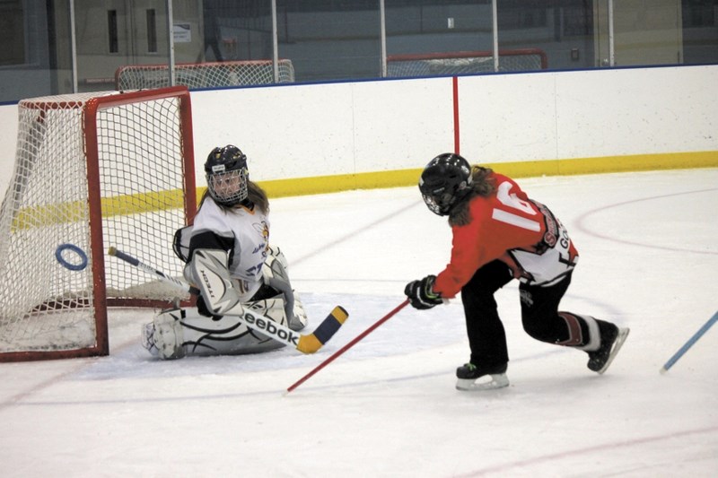 Airdrie Sting goaltender Meaghan Raber turned aside a shot attempt from Jenna Goodwin of Sherwood Park NRG during the Alberta U12B provincial ringette finals at Genesis Place 