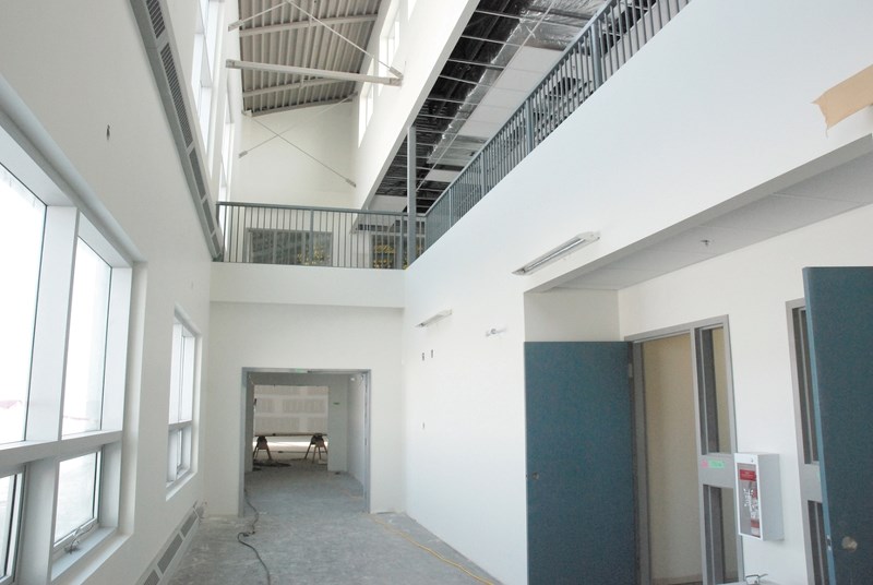 The atrium located in Airdrie Koinonia Christian School (AKCS), sits unfinished after work stopped on the building in December 2013, when more than $4.5 million in liens was