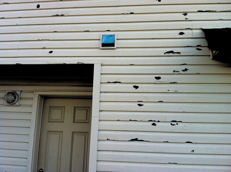 The siding on this home in Luxstone will need some substantial repairs after a major hailstorm hit Airdrie on Aug. 7.