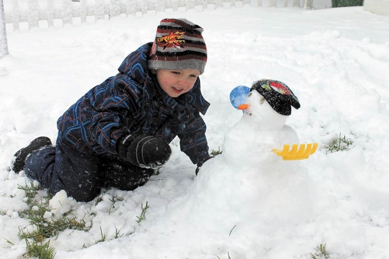 Ashton Nicholson built a snowman in his front yard on Williamstown Close on Sept. 10 as Airdrie was hit with an early taste of winter weather.