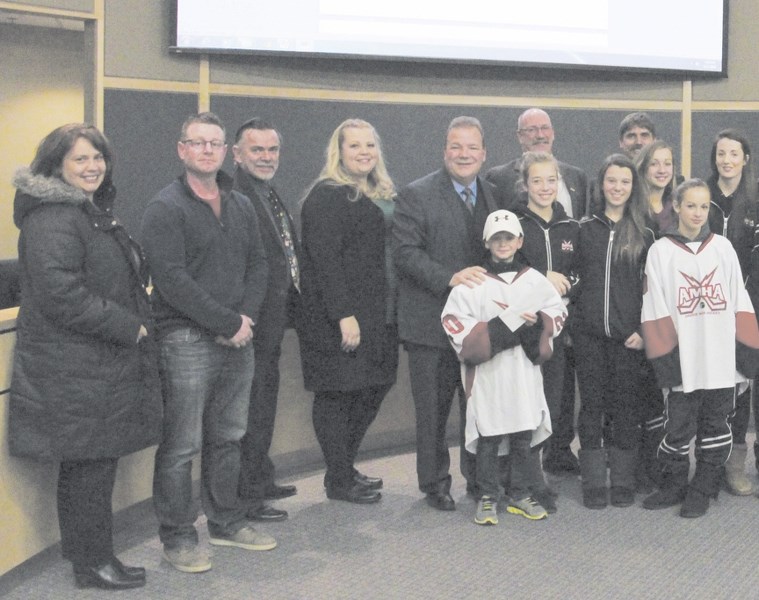 Members of the Airdrie Minor Hockey Association went to the Airdrie City council meeting on Dec. 1 to present the City with a cheque for $71,000.